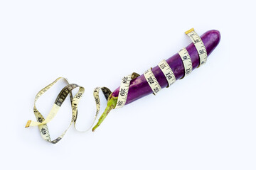 Long purple eggplant wrapped in measuring tape on white background.