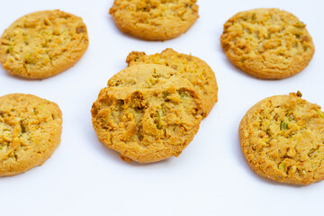 Pistachio and almond cookies on white background.
