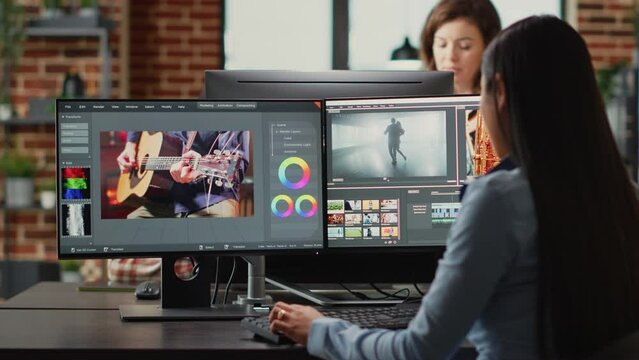 Graphic designer creating professional movie content with filmmaking software in agency office, creative digital film. Cinematographer editing video footage with lighting and focus, videography.