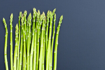 Fresh asparagus on dark background.