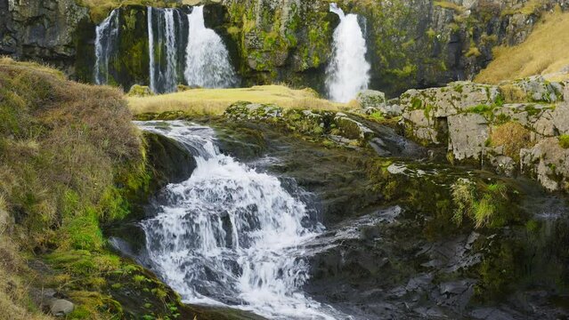 Autumn Waterfall in Iceland. Pure Turquoise Water in Mountain River. Popular Tourist Spot. Famous Travel Destination. Beautiful Nature, Unusual Landscape. Footage Shot in 8K Resolution 4320p