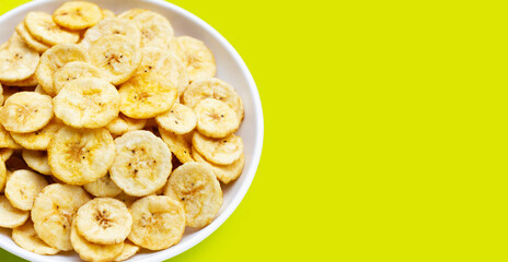 Banana slice chips on green background.