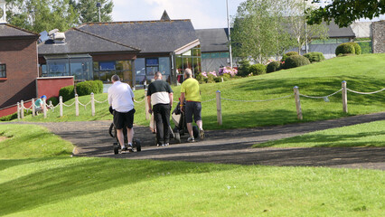 Gentlemen Golfers playing a round of golf on a sunny day at a course on a resort in UK