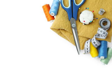 Set of different sewing accessories on white background, top view