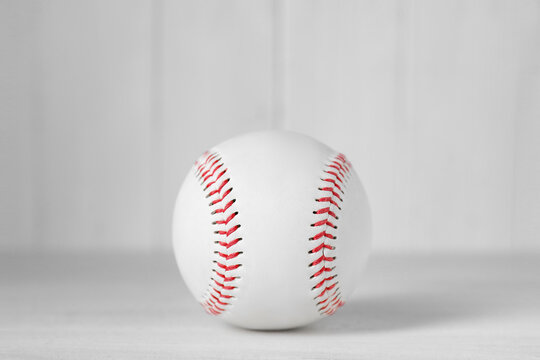 Baseball ball on white table, closeup. Sportive equipment
