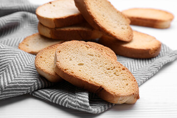 Tasty hard chuck crackers on white wooden table, closeup