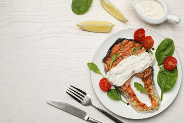 Tasty salmon steak served on white wooden table, flat lay. Space for text