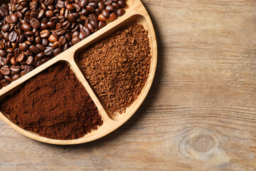 Instant, ground coffee and roasted beans on wooden table, top view. Space for text