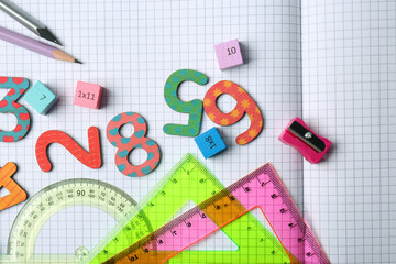 Flat lay composition with colorful numbers on notebook with grid pages