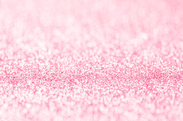 Pink bright defocused glitter texture background.