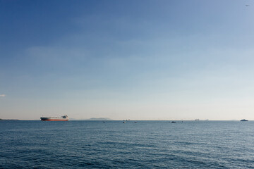 Beautiful landscape with blue sea and blue sky and a large ship in the distance on the horizon. Bosphorus, Istanbul, Turkey, 1 November 2022