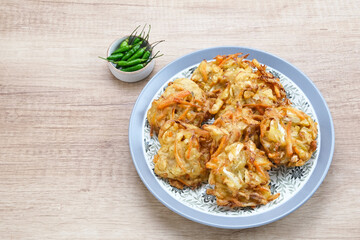 Bakwan sayur or bala-bala or vegetable fritter, Indonesian snack made from flour, cabbage, carrots and bean sprouts, served with chili
