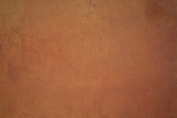 Texture of a rusting substrate. Coarse pored background in tangerine red orange.