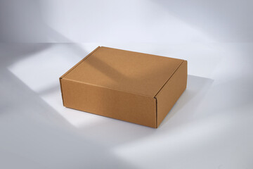Empty cardboard box with window shadow