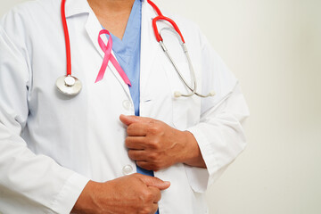 Asian woman doctor with pink ribbon, World Breast Cancer Day at October.