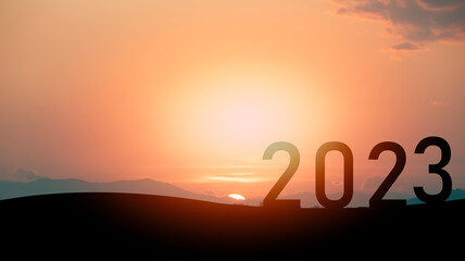 Happy new year 2023 concept, silhouette of number celebration and success with beautiful mountain...
