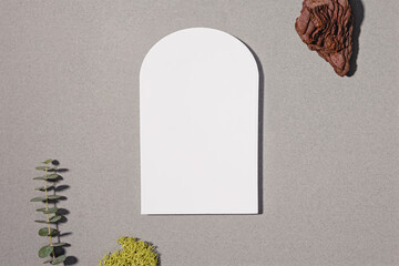 Arch shape mock-up, minimalist modern still life composition with arch stone, eucalyptus branch and moss. Eco materials