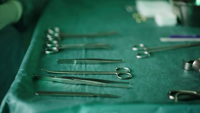 The assistant takes the surgical instruments from the table in the clinic.