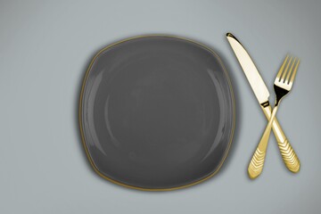 Gold fork and knife cutlery on a desk