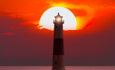 Abstract background with silhouette of lighthouse at amazing sunset