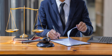 Close up of photo lawyer male notary working in a courtroom on wooden table office, Legal law, advice deal justice and law concept.
