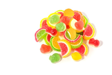 Multicolored sweet fruit marmalade with loose jelly candies on a white isolated background.