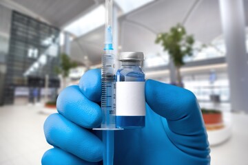 Hand hold a vaccine on hospital background