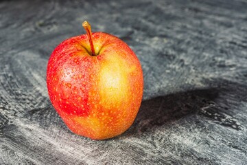 Drops of water on a ripe apple - appetizing and healthy food