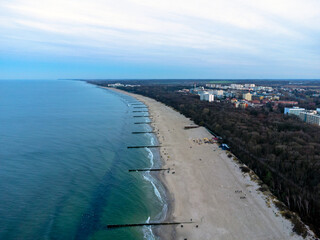 Aerial view. Seascape. The setting sun. Beach, sand, sea , water , waves. Winter season. Photo from a drone.