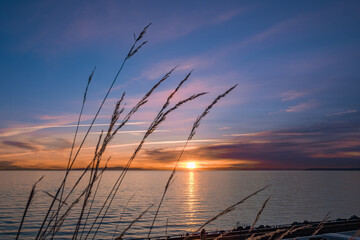 Sunrise over the sea and beautiful cloudscape. Colorful ocean beach sunrise with deep blue sky and sunrays Sunset, beach