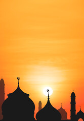 Silhouette Mosque domes against sunrise sky in the morning with beautiful orange sunlight in Iftar period during Ramadan Holy month