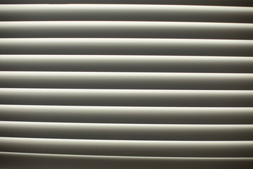 Obraz premium Blinds on window. Leakage of blinds. Window in afternoon.