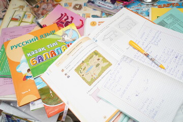 Almaty, Kazakhstan - 05.18.2022 : School notebooks and textbooks in the child's room.