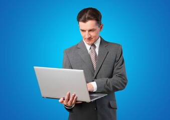 Young smart man with laptop computer