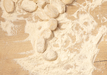 Dough with flour on the table.