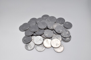 Pile of Indonesian thousand rupiah coins isolated on a white background