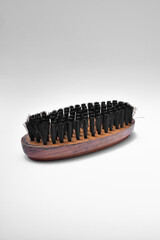 bristle brush isolated on white background, bristle wooden brush for leather shoe polish.