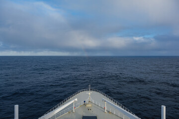 Rainbow at sea after storm during transatlantic passage on legendary ocean liner cruiseship cruise...