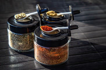 Seasonings and spices red pepper, oregano and cumin on black background 