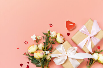 Valentine's Day, Women's Day, birthday, mothers day greeting card background with handmade present box and spring flower on pink background. View from above.