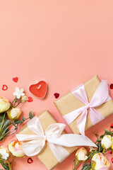 Valentine's Day, Women's Day, birthday, mothers day greeting card background with handmade present box and spring flower on pink background. View from above. Copy space.