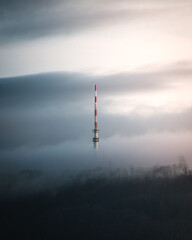 Obraz premium German SWR broadcasting tower in the morning surrounded by clouds
