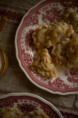 plate with hot dumplings and onion fry close-up top view. ukrainian traditional food vareniki with...