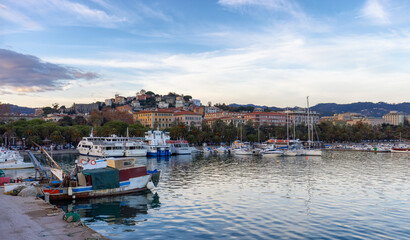 Fototapeta premium Boats at a marina in a touristic city, La Spezia, Italy. Sunset Sky.
