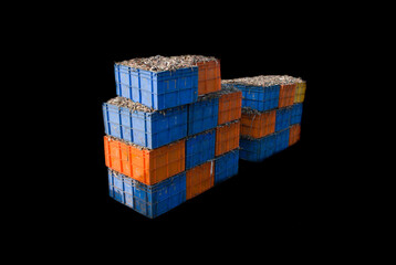 Indian fish export containers tower isolated on black.