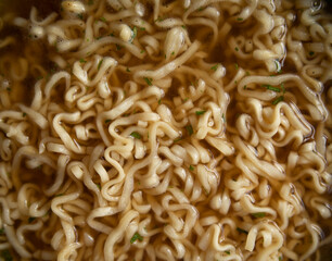 ramen noodles close-up. broth ramen macro photo. Asian instant noodles with spices soaked in water