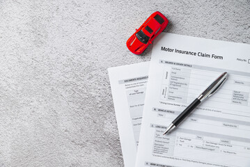 Motor or car insurance claim form with ballpoint pen and car model