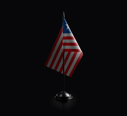 Small national flag of the Liberia on a black background