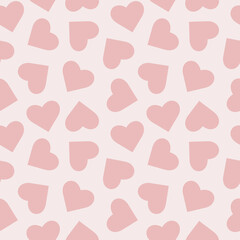 Seamless pattern with chaotic pink hearts for Valentine's day. Can be used for textile, book covers, wallpapers, gift wrap. Isolated vector illustration on light pink background.