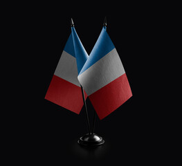 Small national flags of the France on a black background